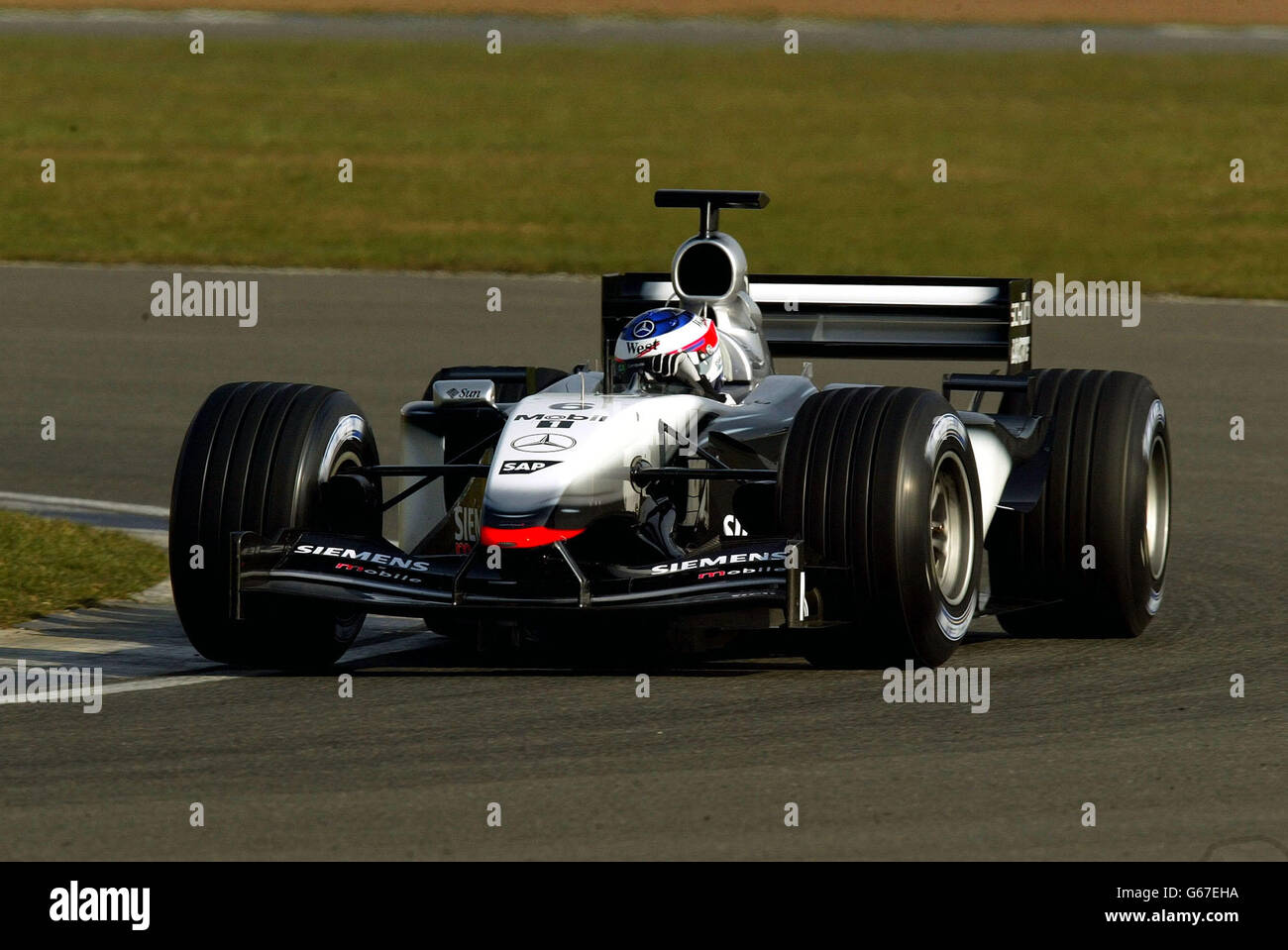 Kimi Raikkonen in his McLaren during pre season testing at Silverstone. Stock Photo
