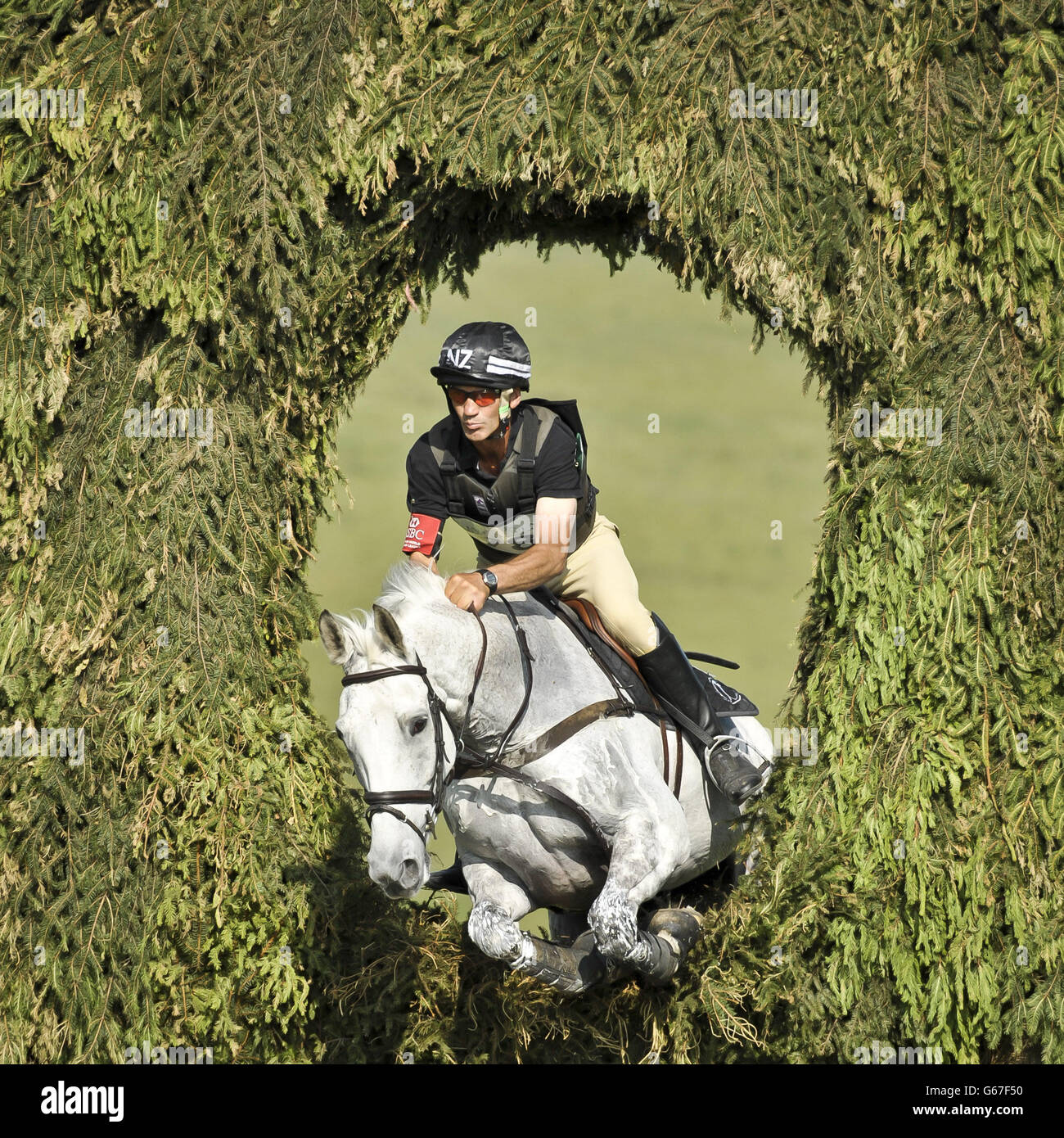 Winner of the CIC *** Section A New Zealand's Andrew Nicholson on Avebury leaps through the Owl Hole in the Cross Country during day four of the Barbury International Horse Trials at Barbury Castle, Wiltshire. Stock Photo