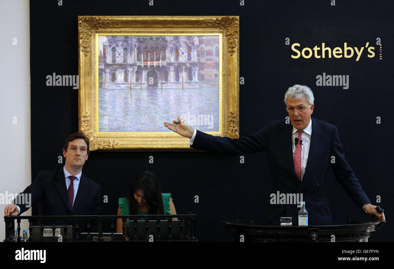 An auctioneer accepts bids whilst stood in front of Claude Monet's 'Le Palais Contarini' during the Sotheby's Impressionist and Modern Art Evening Sale, St. George Street, London. Stock Photo
