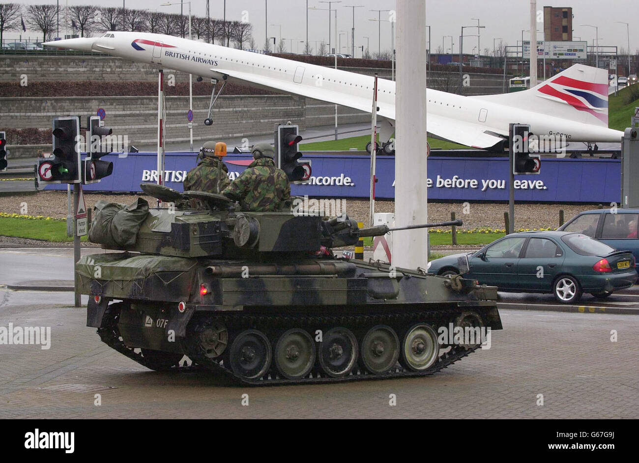 Soldiers in an armoured car stand guard in front of a model of a BritIsh Airways Concorde near the entrance to London's Heathrow airport. * Scotland Yard said that the troops had been moved in to support the Metropolitan Police as they stepped up security at the airport and other locations. 12/8/03: The United States has sent aviation experts to Iraq and major capitals in Europe and Asia to assess the security of commercial airports. The investigators are determining whether the airports can be defended against shoulder-fired missiles. The US Homeland Security Department is also asking Stock Photo