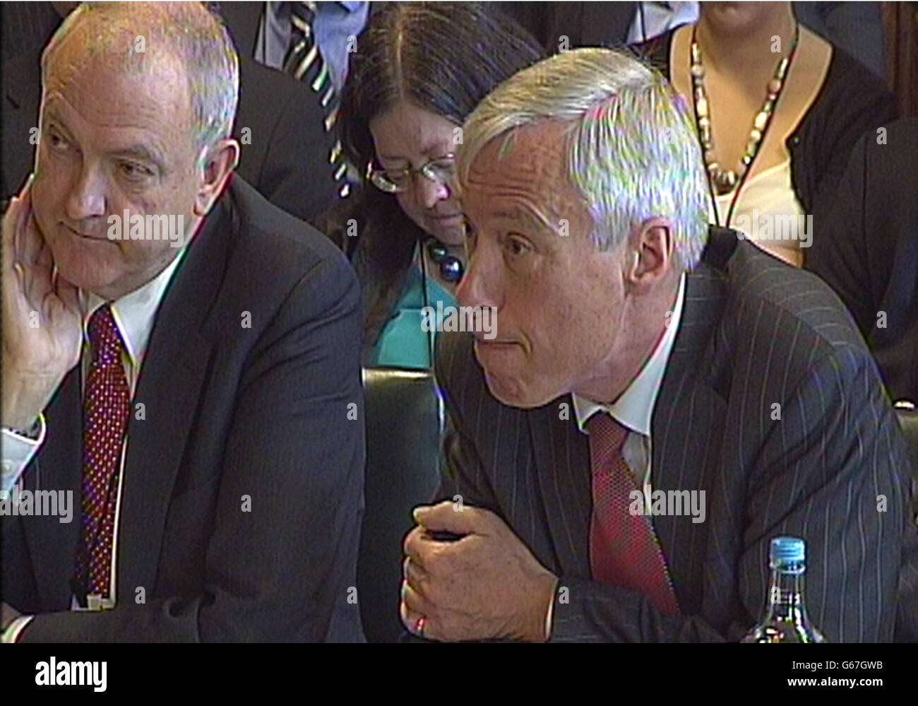 (Left to right) NHS medical director Sir Bruce Keogh and Right Honourable Earl Howe give evidence to Commons Health Committee on emergency services. Stock Photo