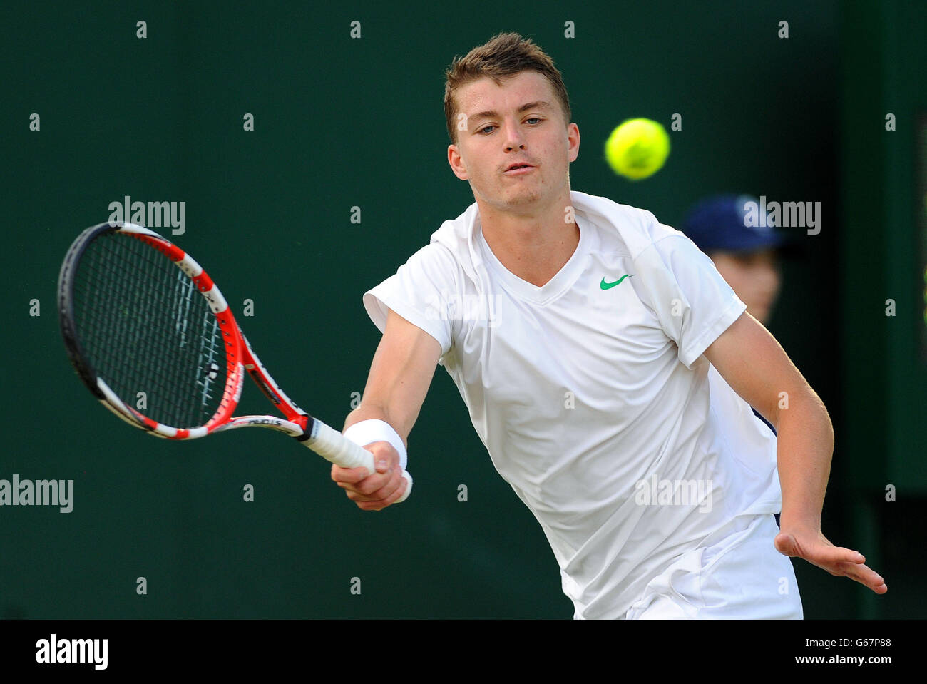 Great Britain's Jonny O'Mara in action against France's Maxime Janvier in his Boy's Singles match during day seven of the Wimbledon Championships at The All England Lawn Tennis and Croquet Club, Wimbledon. Stock Photo