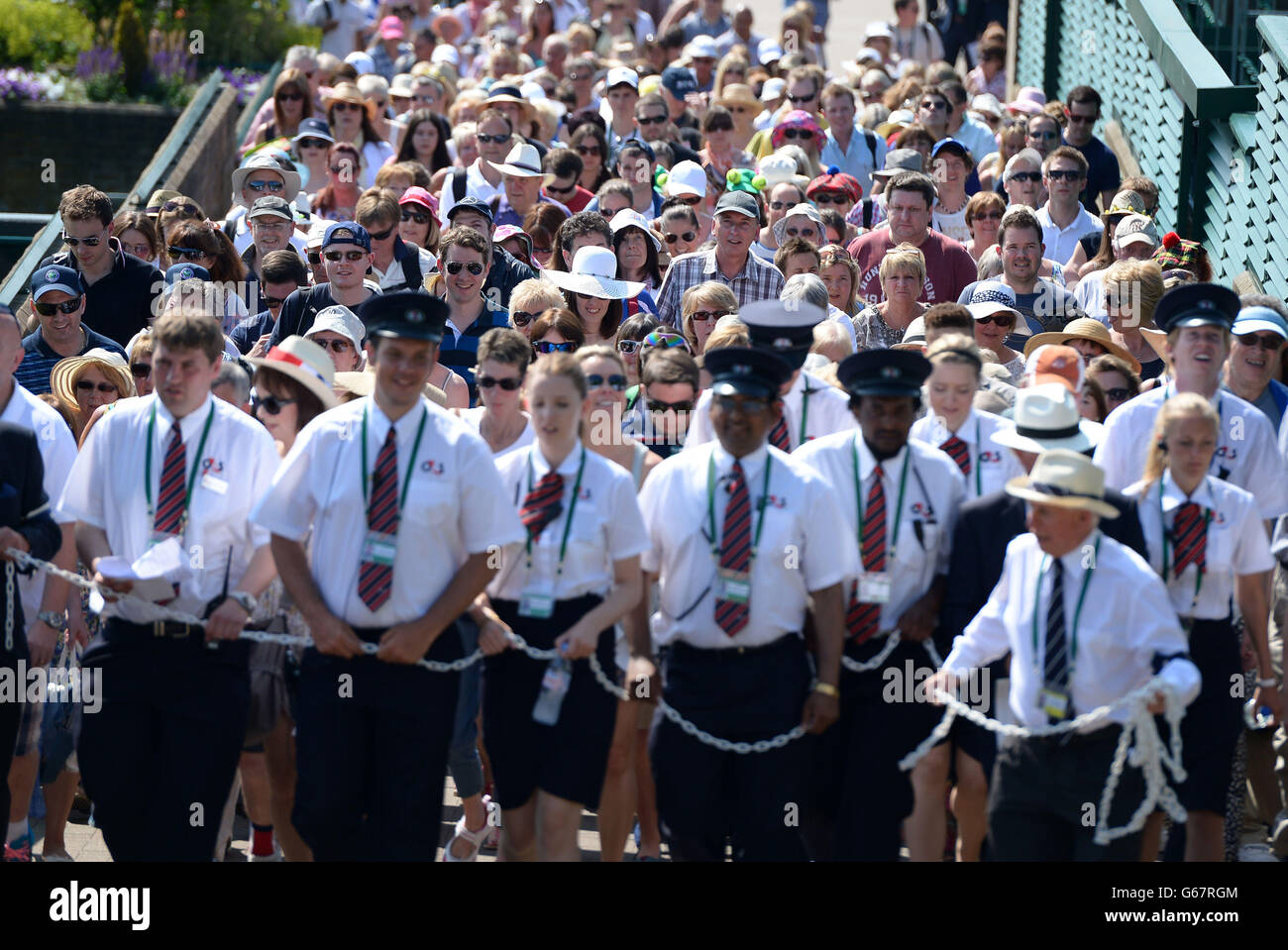 Fans are walked to Murray Mount during day thirteen of the Wimbledon Championships at The All England Lawn Tennis and Croquet Club, Wimbledon. Stock Photo