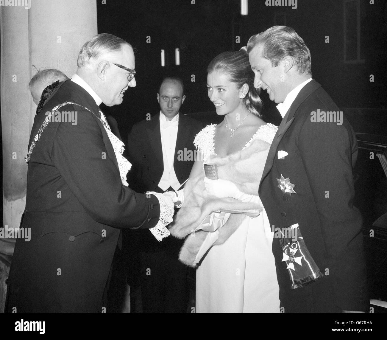 Princess Paola and her husband Prince Albert of Liege are greeted by Sir Lionel Denny, Lord Mayor of London, on their arrival at Mansion House. They were attending the 75th anniversary banquet of the Belgian Chamber of Commerce in Great Britain. Stock Photo