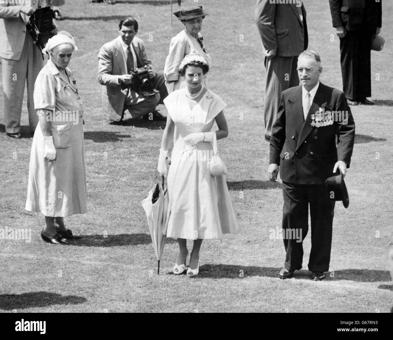 Sir Raymond Huish, President of the Queensland League of Returned Soldiers, meets Queen Elizabeth II on her arrival at the Brisbane exhibition grounds, where the Queen held a review of ex-servicemen and women. Stock Photo