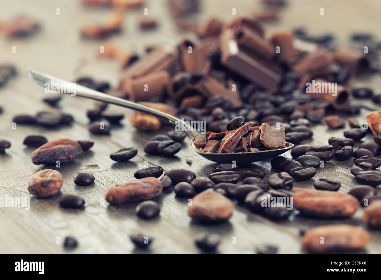 Chocolate pieces with cocoa and coffee beans on a wooden table Stock Photo