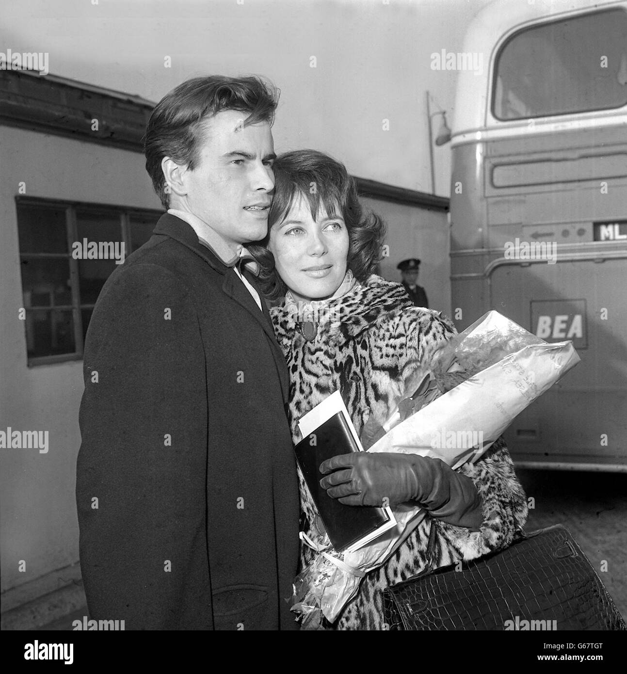 Library filer of film star Horst Buchholz with his wife, Myriam, at London Airport from New York, March 25, 1962. Buchholz, whose Hollywood credits included The Magnificent Seven died, Monday March 3, 2003, in Berlin. He was 69. Dubbed the James Dean of German films for rebellious teens he played in the late 1950s, Buchholz moved to United States and scored his first Hollywood hit with the 1960 Western The Magnificent Seven, starring with Yul Brynner, Steve McQueen, James Coburn and other action stars. See PA Story GERMANY Buchholz Stock Photo