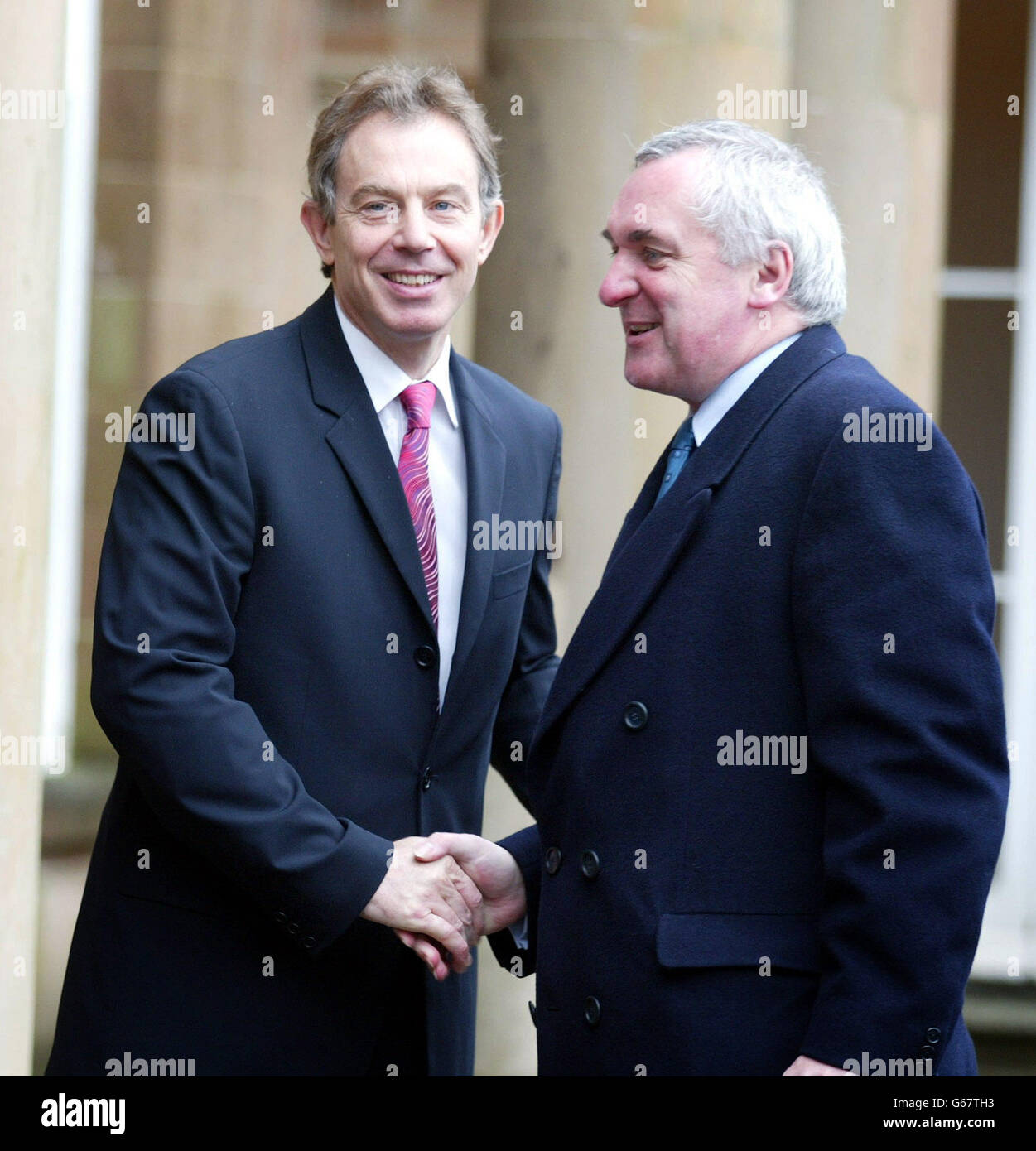 British Prime Minister Tony Blair (left) welcomes Taoiseach Bertie Ahern outside Hillsborough Castle, County Down, Belfast, on the second day of the Northern Ireland Peace Process talks. 02/10/2003 British Prime Minister Tony Blair and Irish Premier Bertie Ahern who are due to meet in Rome, Saturday 4 October 2003, following calls on them to redraw their plans for reviving the Northern Ireland Assembly. The two leaders were due to review efforts to restore devolution following the Ulster Unionist executive's rejection of the two governments' joint declaration for implementing the Good Friday Stock Photo