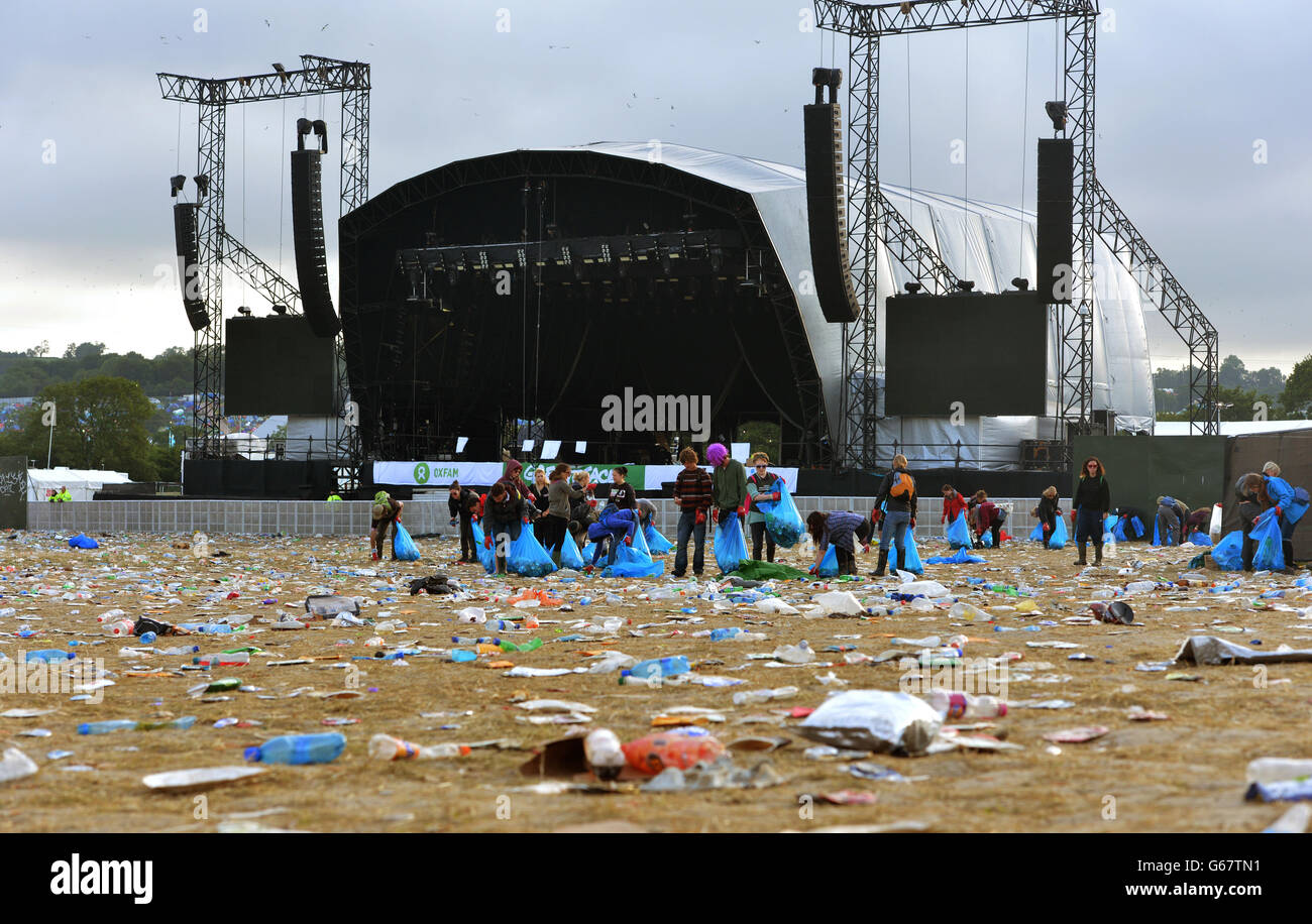 Cleaners pickup litter following the final day of the Glastonbury
