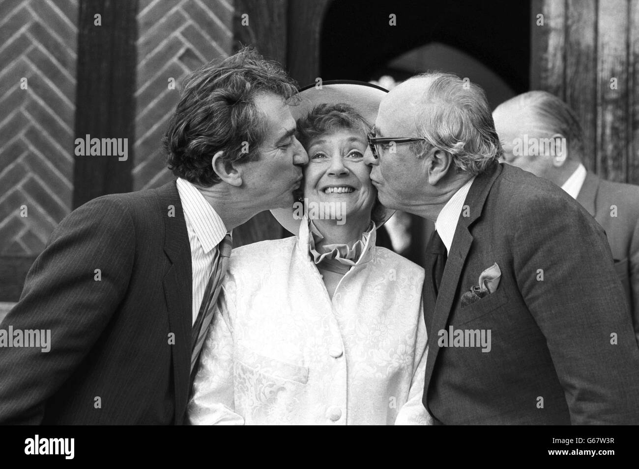 SDP President Shirley Williams receives a kiss from fellow founder members of the party Bill Rodgers (left) and Lord Jenkins, outside the Church of St Edmunds following her wedding to American professor Richard Neustadt. Stock Photo