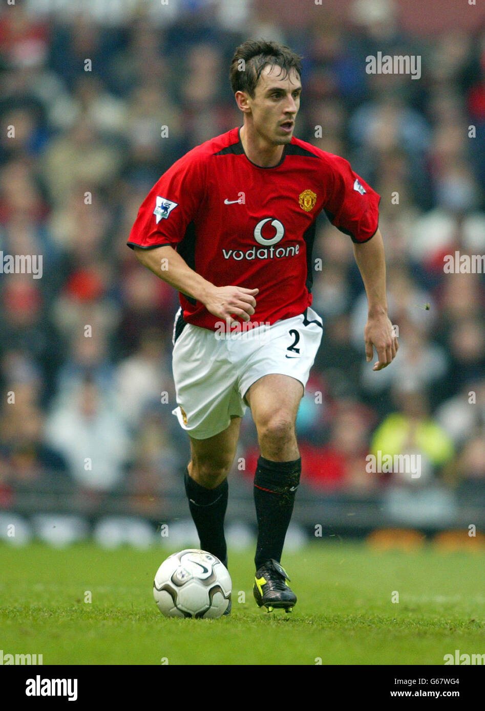 Manchester uniteds phil neville 24 7 04 hi-res stock photography and