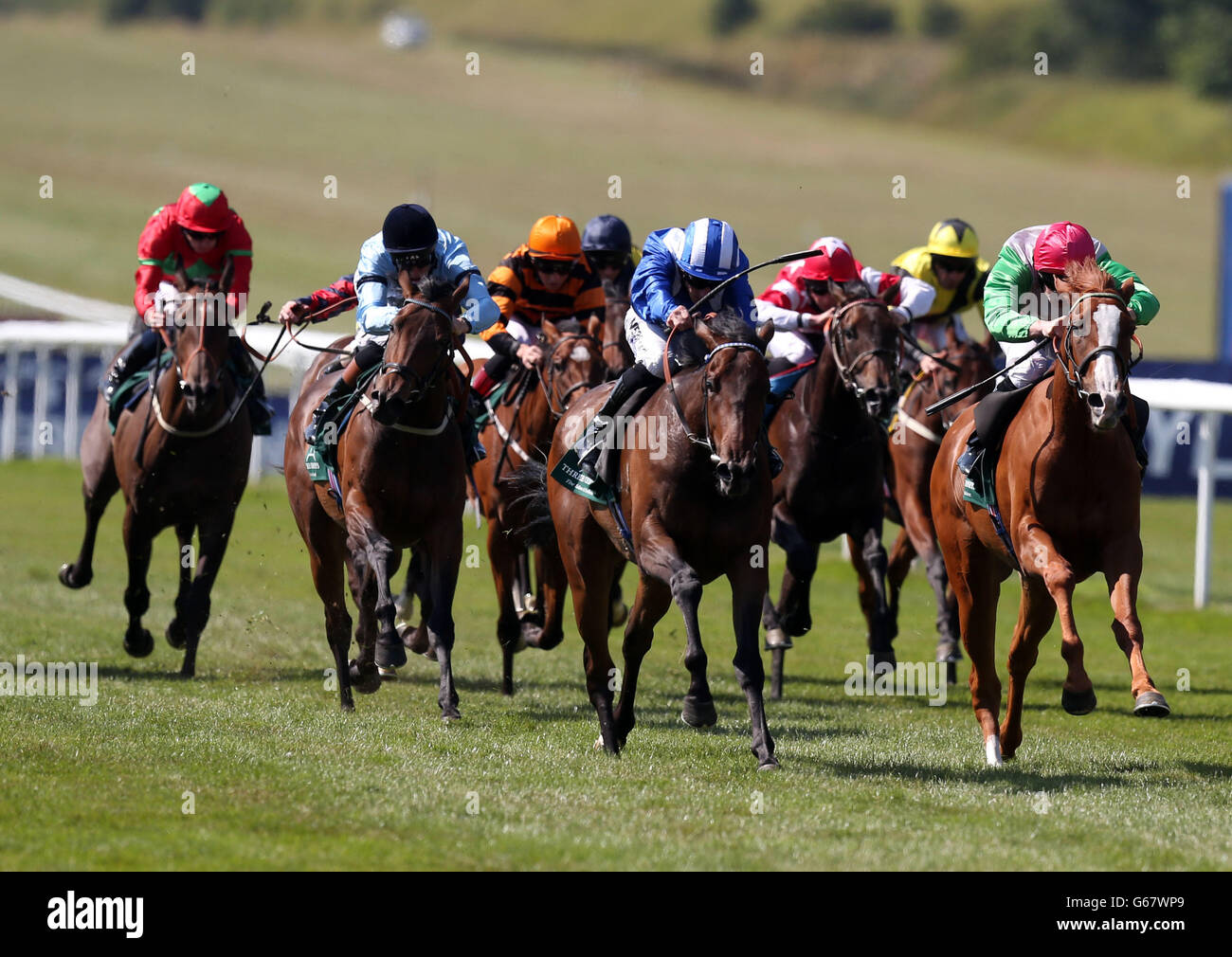 Qawaasem ridden by Paul Hanagan (centre) beats Valonia ridden by Fergus Sweeney (right) to win the Three Chimneys E.B.F. Maiden Fillies Stakes during Boylesport Ladies Day of the Piper-Heidsieck July Festival at Newmarket Racecourse, Newmarket. Stock Photo