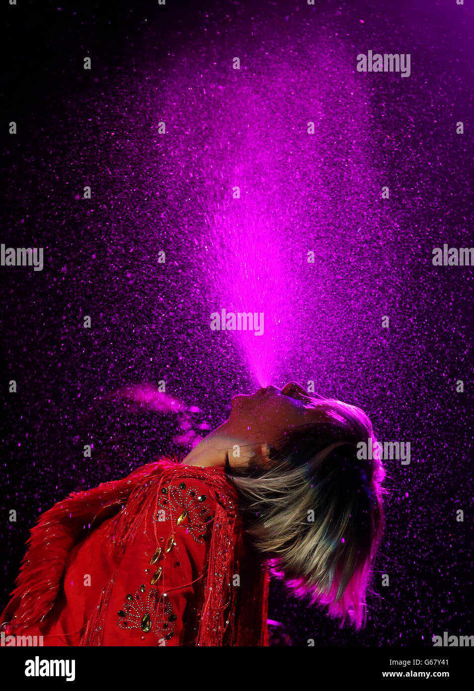 Karen O from the Yeah Yeah Yeahs sprays water whilst performing during the 20th T in the Park music festival at Kinross. Stock Photo