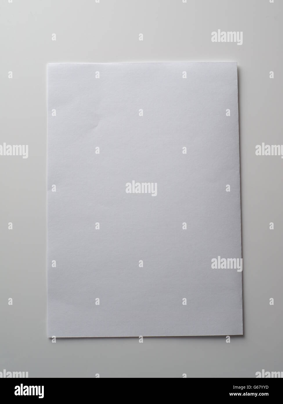 paper a4 on a grey background Stock Photo - Alamy