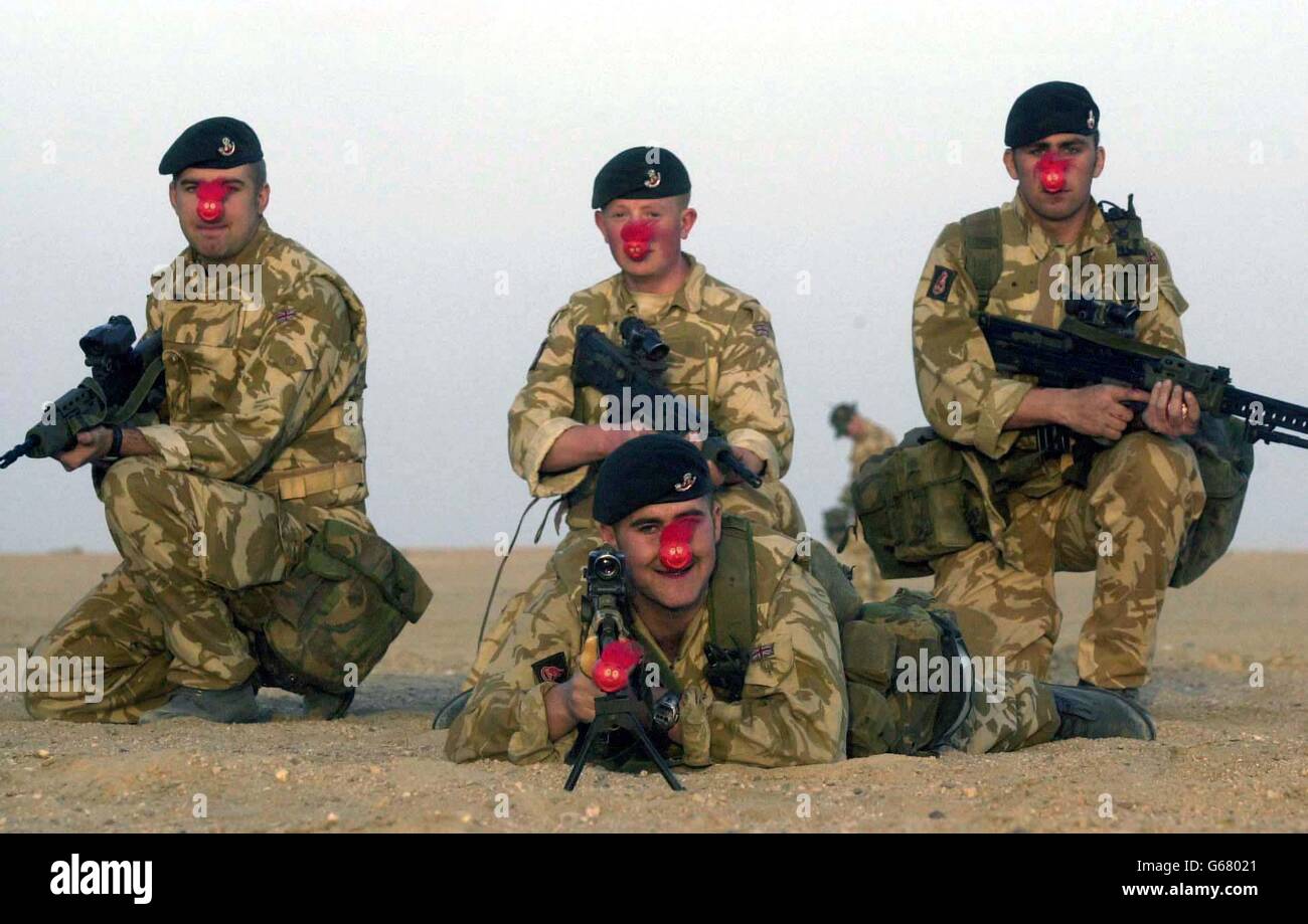 Members of The Kings Own Light Infantry attached to 2nd Royal Tank regiment in Kuwait. (l/r) Brian Roberts front Danny Breene 19 from Sunderland, (rear l/r) Liam Cormish 19 from Liverpool. * ... Paul Ainsley 18 from Co Durham and Craig Patterson 18, manage to find time to contribute to Comic Relief during manouvers, Thursday 13th March 2003. PA Photo/Brian Roberts Pool Photo Stock Photo