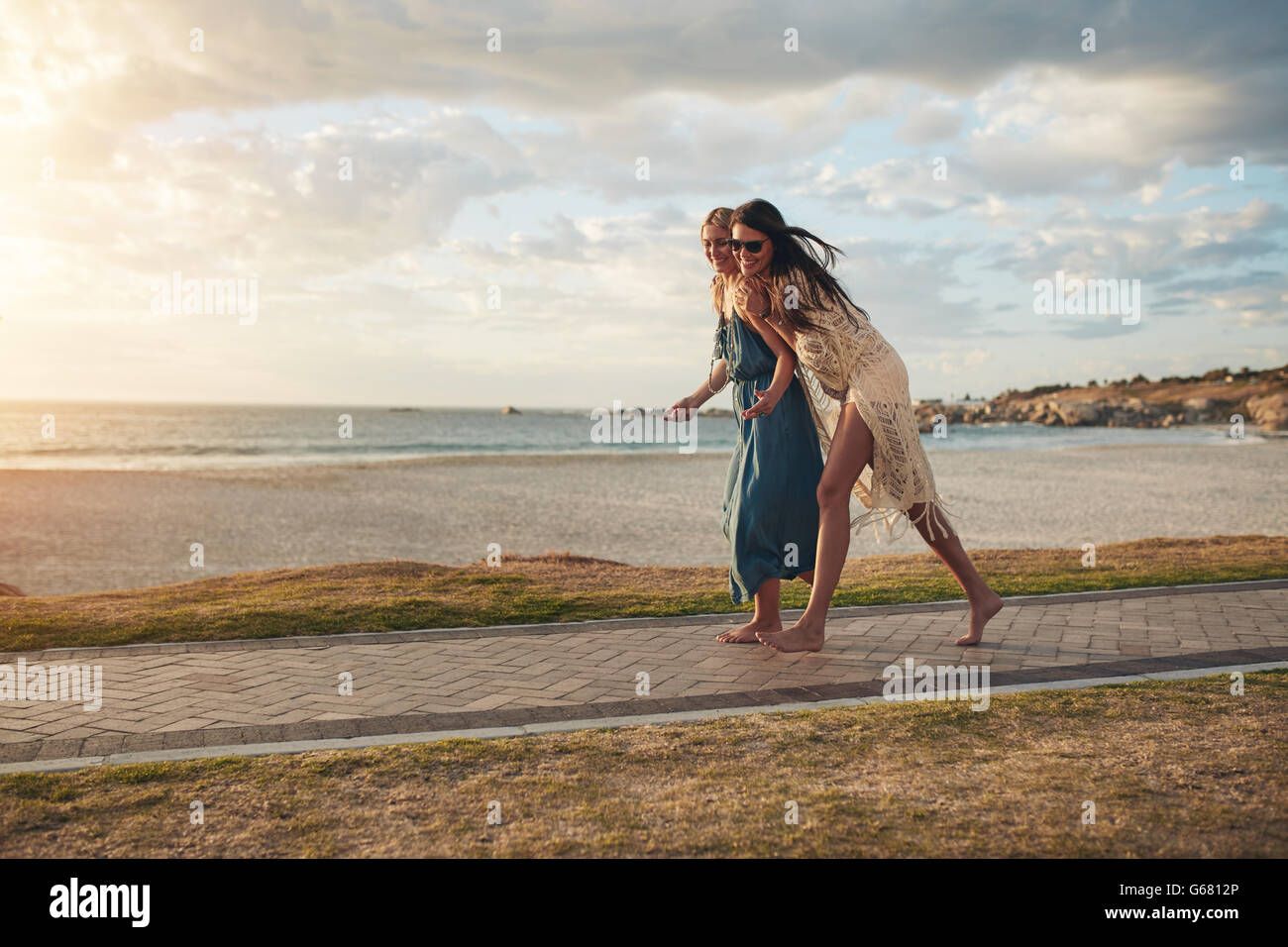 Two women walking beach beach hi-res stock photography and images - Alamy