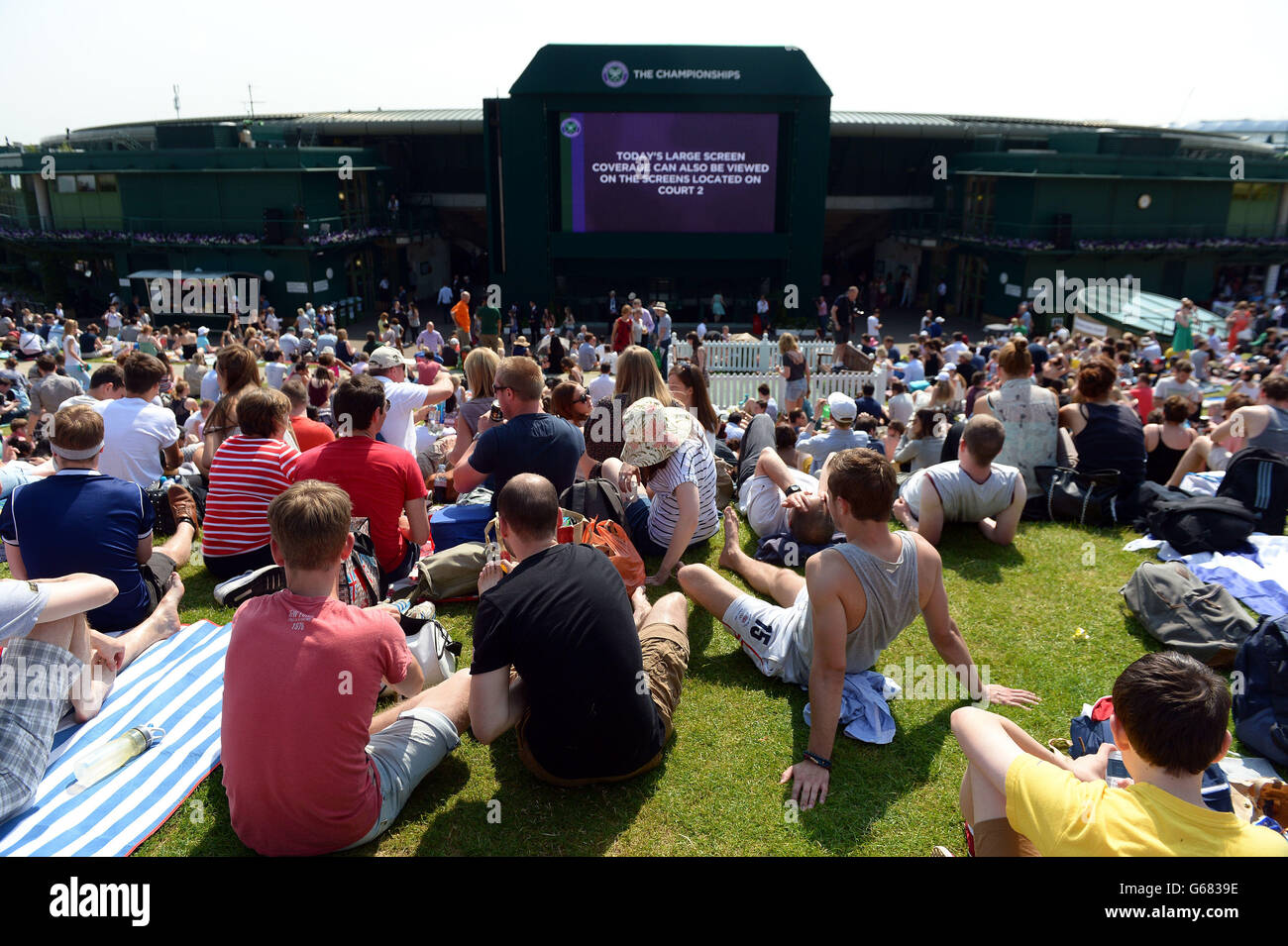 People take their place on Murray Mount after the gates are opened at the start of day eleven of the Wimbledon Championships at The All England Lawn Tennis and Croquet Club, Wimbledon. Stock Photo