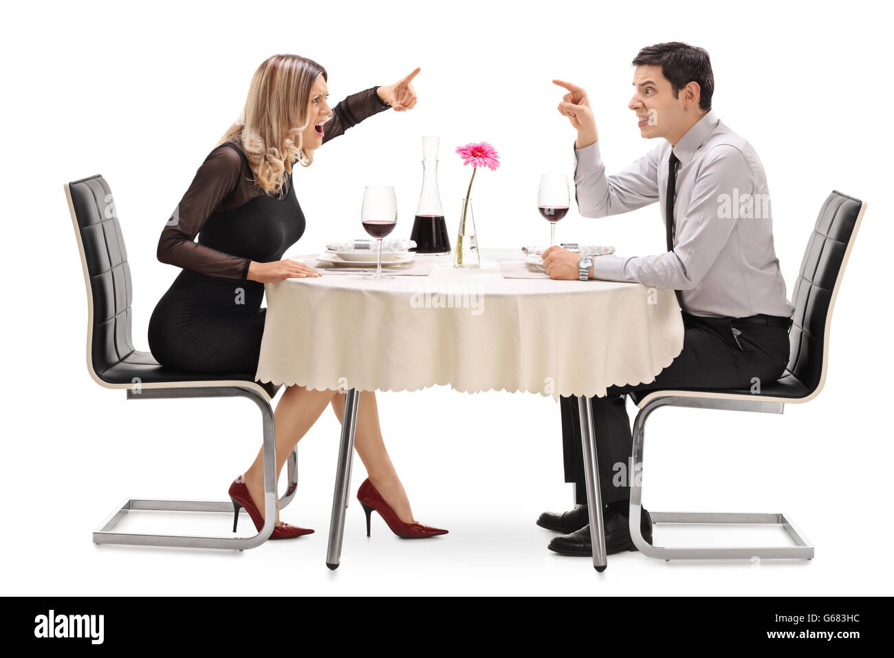 Angry couple arguing with each other on a date at a restaurant isolated on white background Stock Photo