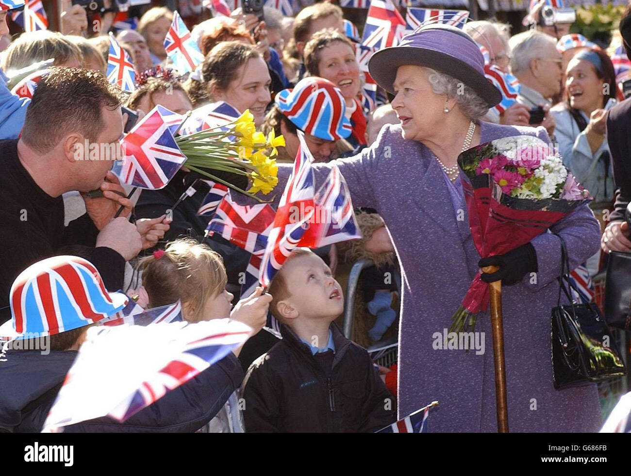 Britain's Queen Elizabeth II meets well wishers and stall holders during a visit to the market square of Romford. A previous Labour administration had famously refused to fly the Union flag above the Town Hall for fear of offending racial minorities. * ... who associated it with extreme right-wing groups, leading to an objection by stallholders, who defeated Havering Council. Stock Photo