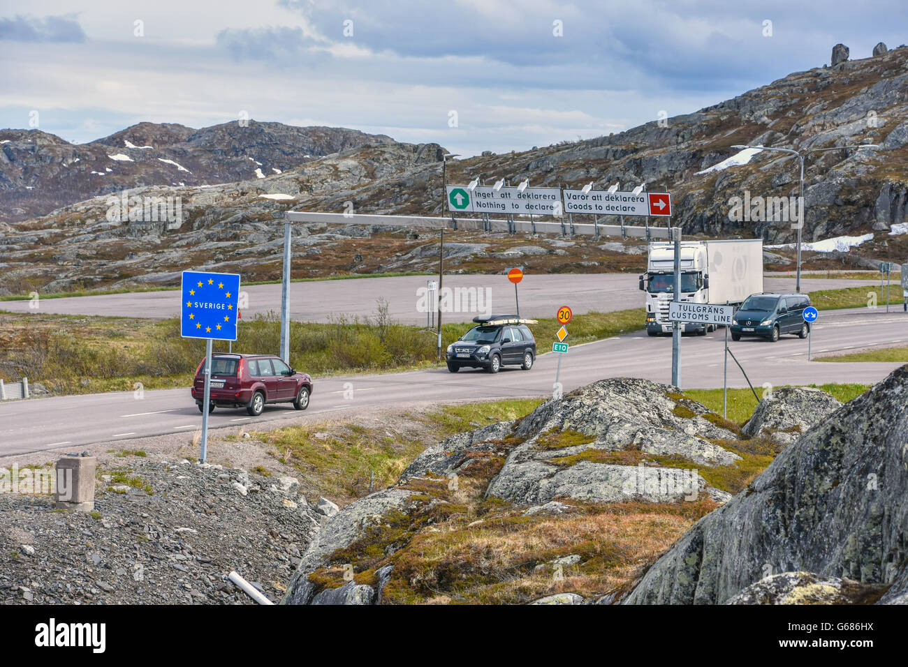 Swedish Norway border with customs signs and vehicles Stock Photo