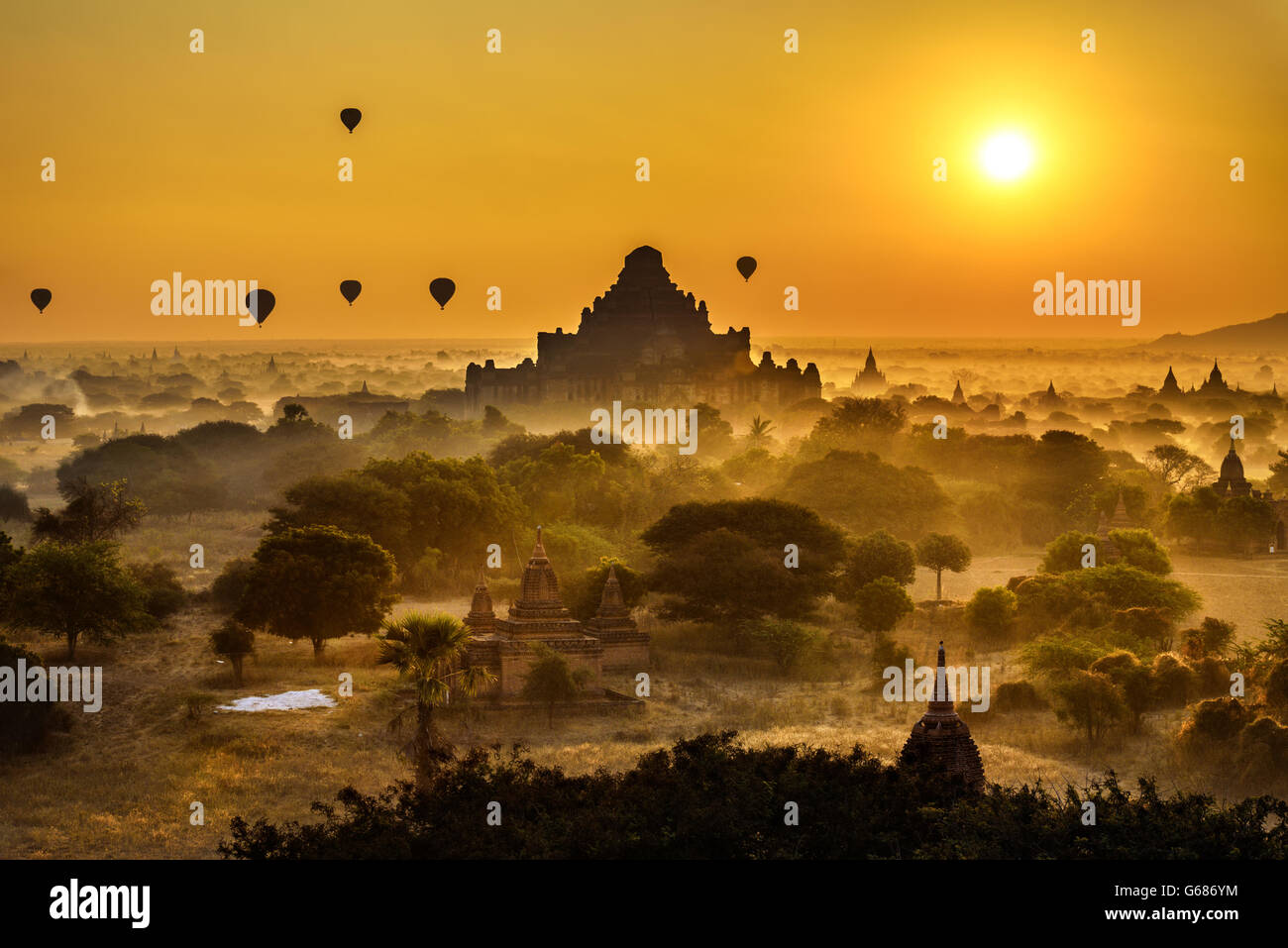 Scenic sunrise with hot air balloons above Bagan in Myanmar. Bagan is an ancient city with thousands of historic buddhist temple Stock Photo