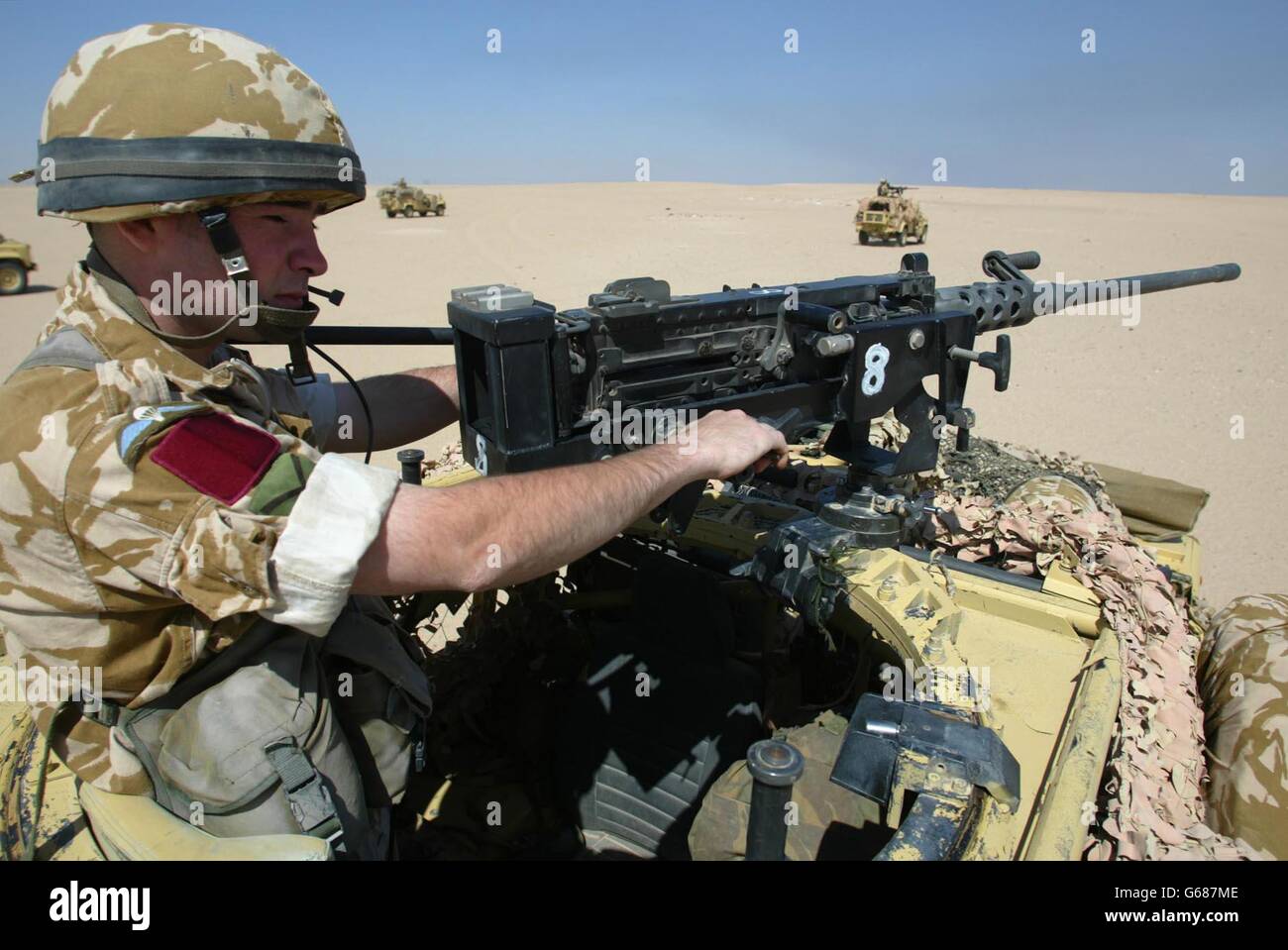 The mobile support group of the 1st Battalion The Parachute Regiment leave their base at Concentration Area Eagle Camp 2 for exercises in the Kuwaiti desert in their WMIK Land Rovers (Weapons Mount Instalation Kit) with 50 calibre machine guns mounted on top. Stock Photo