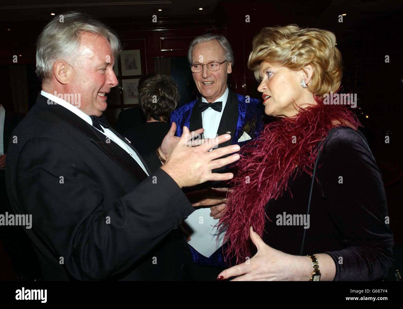 Christopher Biggins talks to Nicholas Parsons and his wife during the Variety Club 51st Annual Dinner & Ball at the Grovesnor House Hotel, central London. Stock Photo