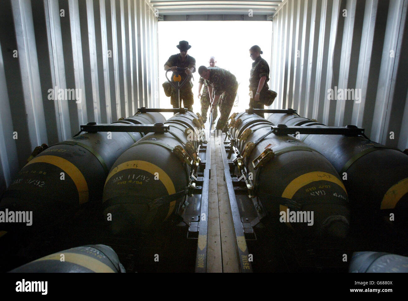 British Royal Air Force weapons technicians unload 1000lb bombs from containers as they ready them for use in their base in Kuwait. Both U.S. and British Royal Air Force Harriers are continuing to patrol the no fly zone in southern Iraq. Stock Photo