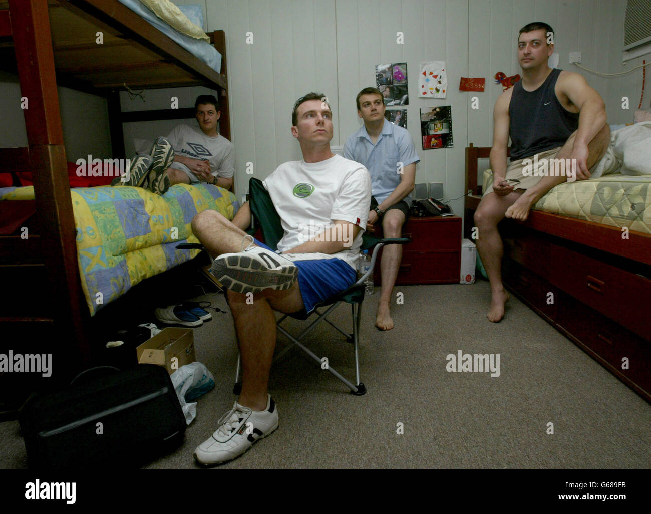 British Royal Air Force Harrier G7 pilots (L to R) Ian Townsend (L), Flt Lt Dominic Hurley (2L), Flt Lt Paul Francis (2R) and Flt Lt Mike Rutland (R) relax in their accommodation on their base in Kuwait. * The pilots are having a rest day from patrolling the no fly zone in southern Iraq. Iraq went onto a war footing just hours before U.S. President George W. Bush was to hold an emergency summit with close allies Britain and Spain that could start the clock for an invasion. Stock Photo