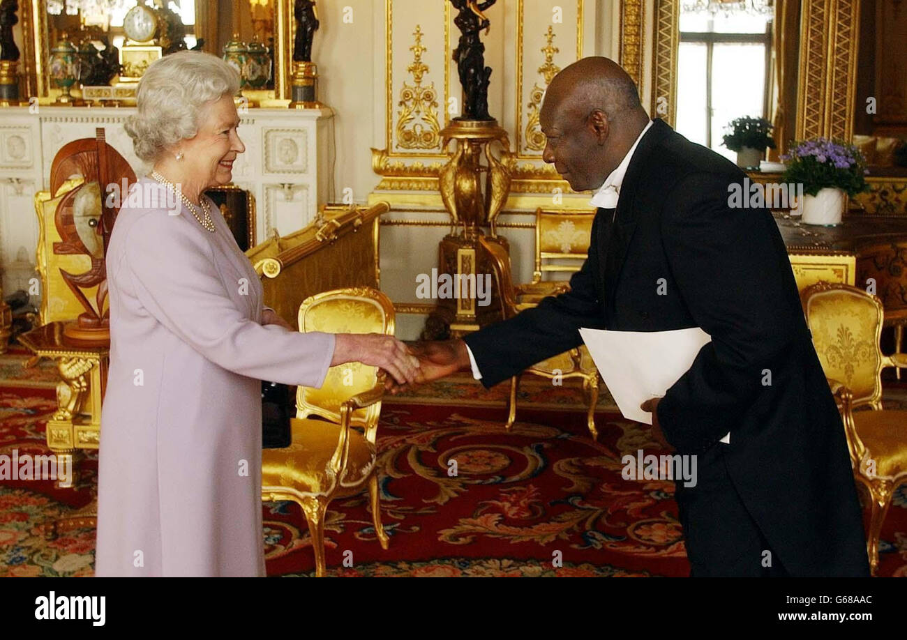 Britain's Queen Elizabeth II shakes hands, with his excellency the Ambassador of Gabon, Mr Alain Mensah-Zoguelet, as he presents his letters of credence at a private audience at Buckingham Palace. Stock Photo