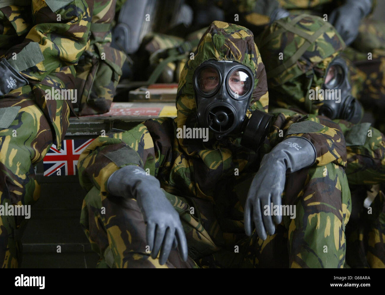 British Royal Air Force personnel wait in a bunker wearing full Nuclear Biological and Chemical suits after a warning of a Scud missile attack on their base in Kuwait. Stock Photo