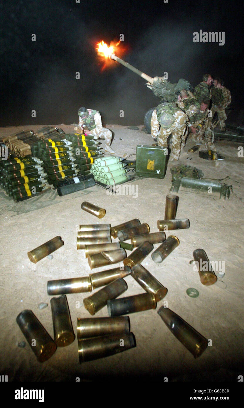 Soldiers from 29 Commando Regiment Royal Artillery fire their 105mm light guns from a position in the Kuwait desert at targets in Southern Iraq during the first night of the allied campaign. * Three Commando Brigade which incorporates 29 Commando are at the forefront of initial engagements into Southern Iraq securing strategic sites and destroying military installations. Stock Photo