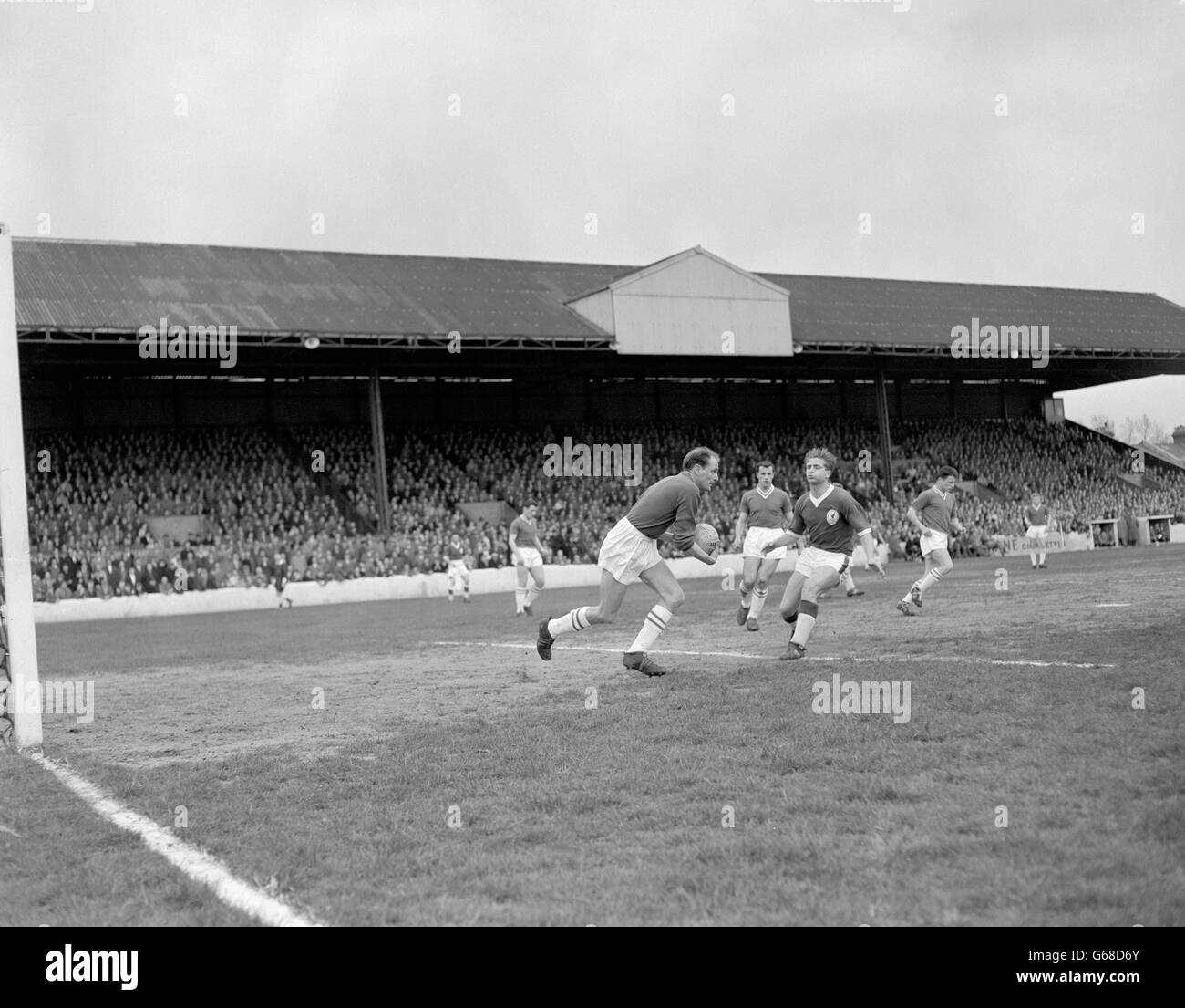 Liverpool's centre forward Dave Hickson rushes in as Leyton Orient goalkeeper David Groombridge clears the ball during the Second Division match at Brisbane Road in London. Archive-PA82948-2 Stock Photo