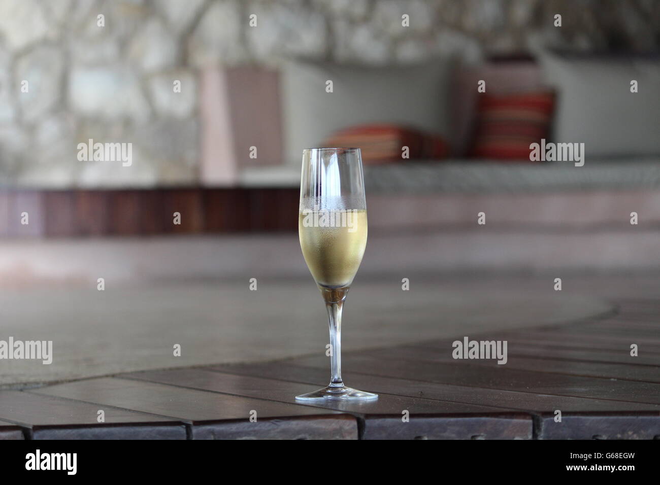 A glass of champagne in a lounge area Stock Photo
