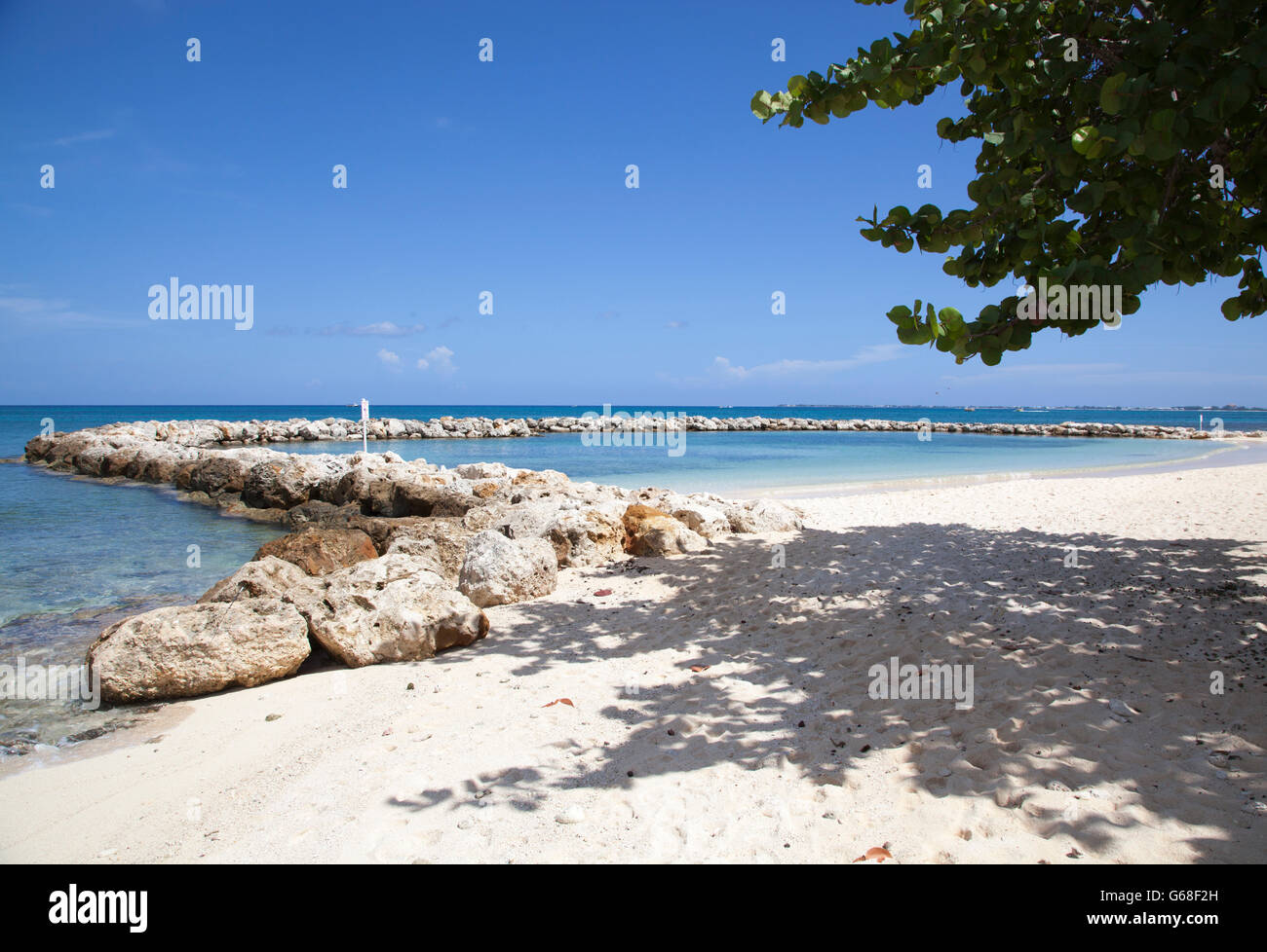 The view of natural swimming pool surrounded by stones on Seven Mile Beach (Grand Cayman). Stock Photo