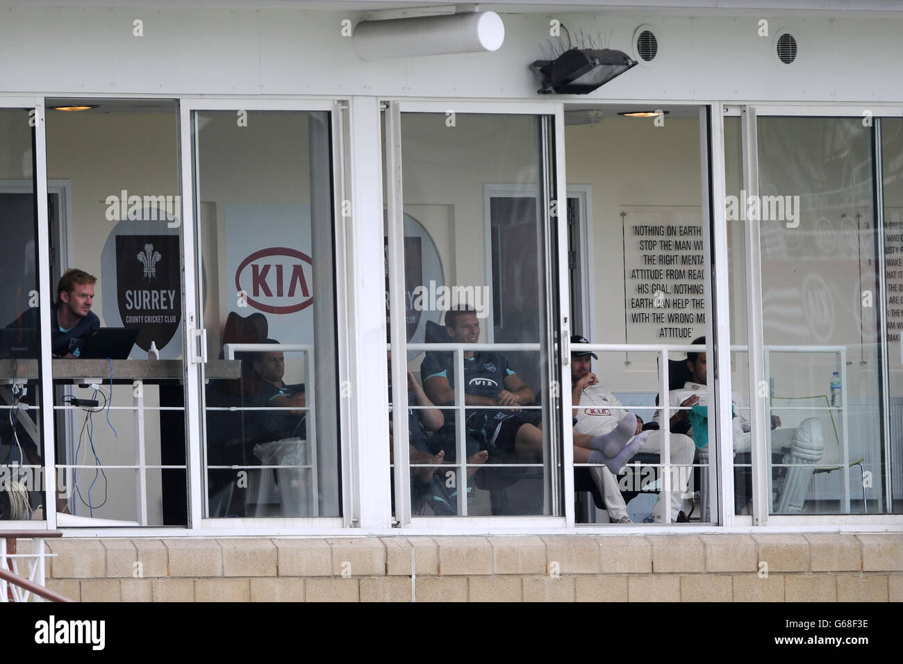 (left to right) Surrey Professional squad analyst & performance manager David Court, Zander De Bruyn, Chris Tremlett and Ricky Ponting watch from the pavilion Stock Photo