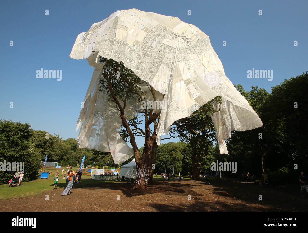 A woman takes pictures of art installation 'Touring Tama' created by artist Mariam McConnon exhibited as part of the Street Performance World Championships in Merrion Square, Dublin. Stock Photo