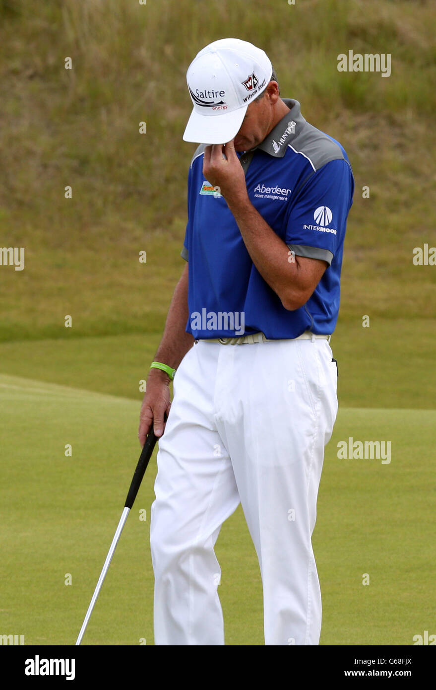 Paul Lawrie reacts after a member of the public shouted as he played the ball on the 14th during day two of the Aberdeen Asset Management Scottish Open at Castle Stuart Golf Course, Inverness. Stock Photo