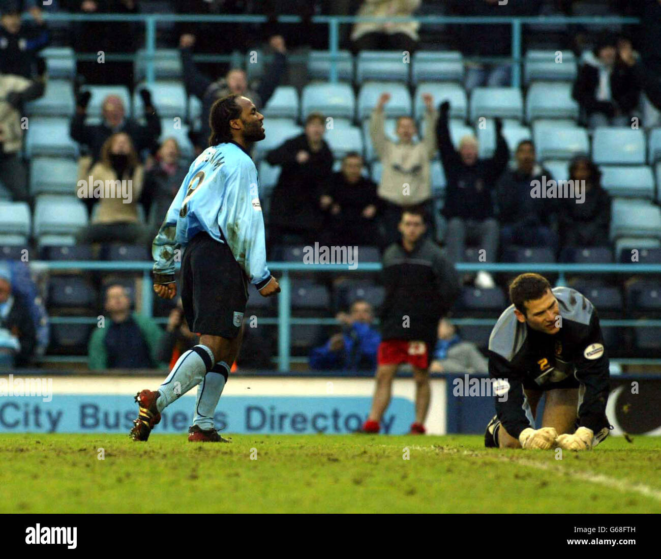 Julian Joachim celebrates scoring as Wimbledon 'keeper, Kelvin Davis looks on, during their Nationwide Division One match at Highfield Road, Coventry. NO UNOFFICIAL CLUB WEBSITE USE. Stock Photo