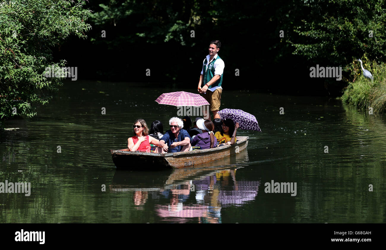 Punters enjoy the summer sunshine as they make their way along the river Cam in Cambridge. Stock Photo