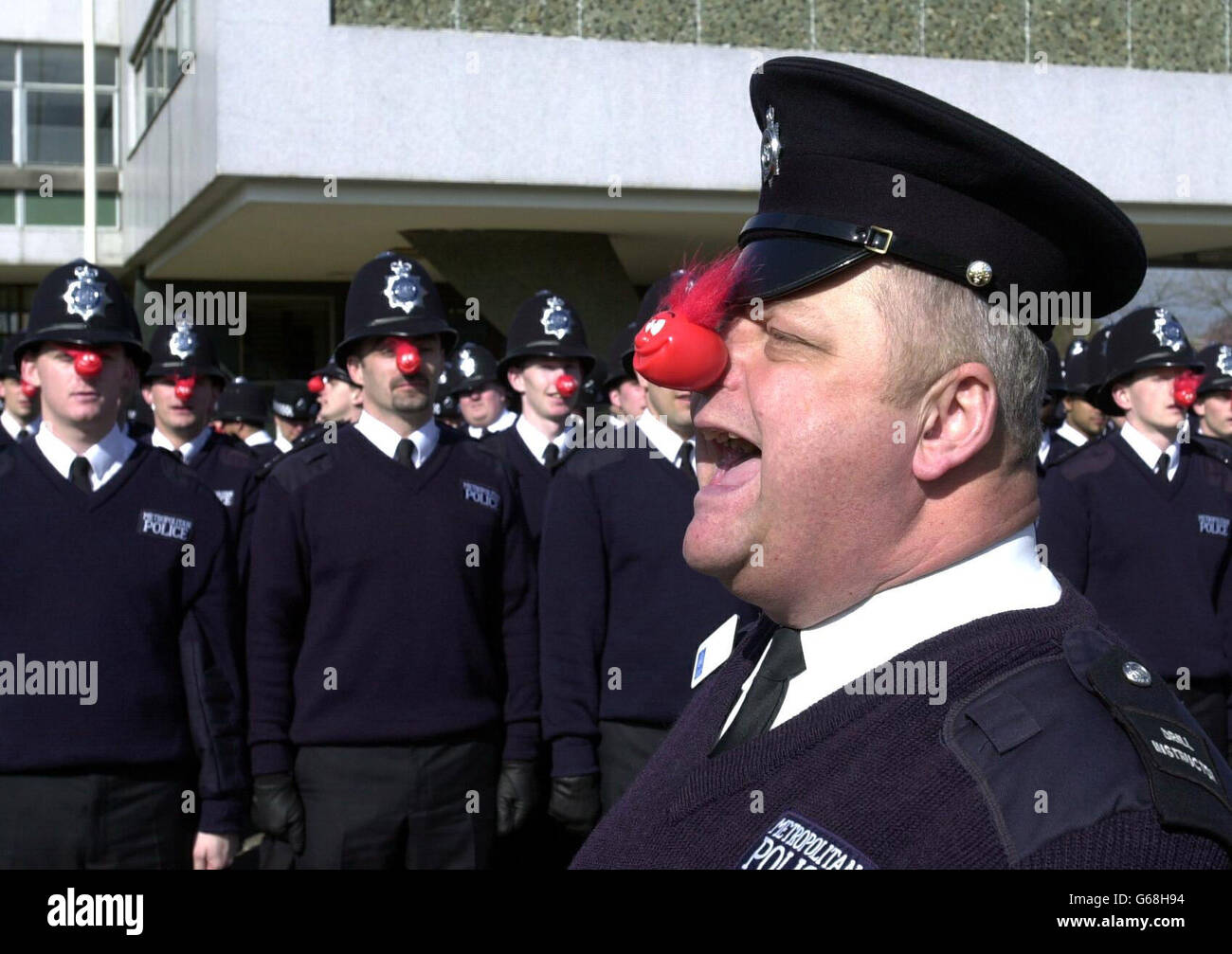 Drill instuctor Peter Clements from Stevenage in charge of police recruits wearing red noses in a rehearsal for their passing out parade on Friday March 14 2003 at Hendon Training School, North London. *..The new recruits have undertaken a range of activities to raise more than 7,000 for a local charity, North London Hospice. Charity events included a sponsered diet and a Cadbury's Creme Egg Eat-a-thon. Stock Photo