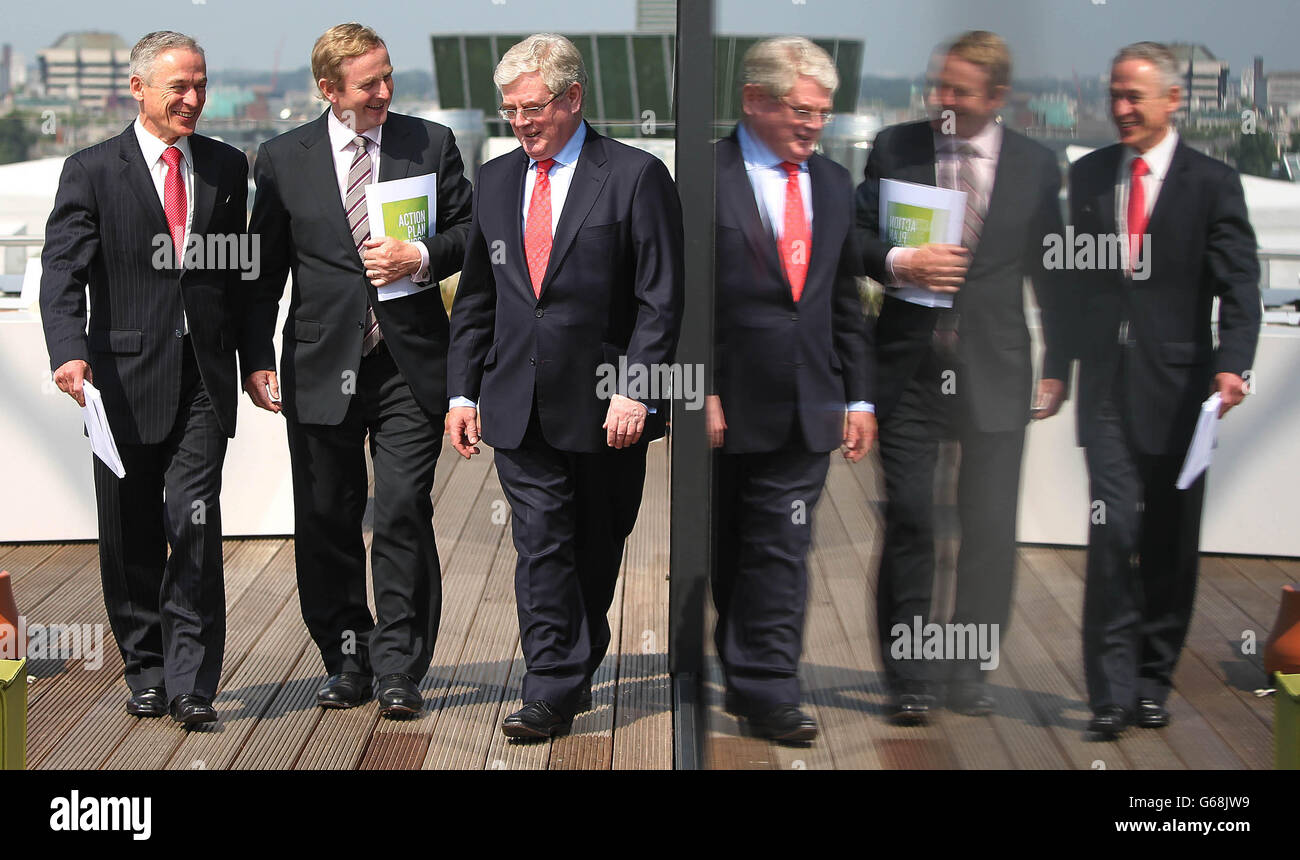 (Left to right) Jobs Minister Richard Bruton, Taoiseach Enda Kenny and Taniste Eamon Gilmore on the roof of the Marker Hotel in Dublin this morning as seventy five jobs are to be created across three multinational companies in Co Laois, Co Galway and Co Longford it was announced. Stock Photo