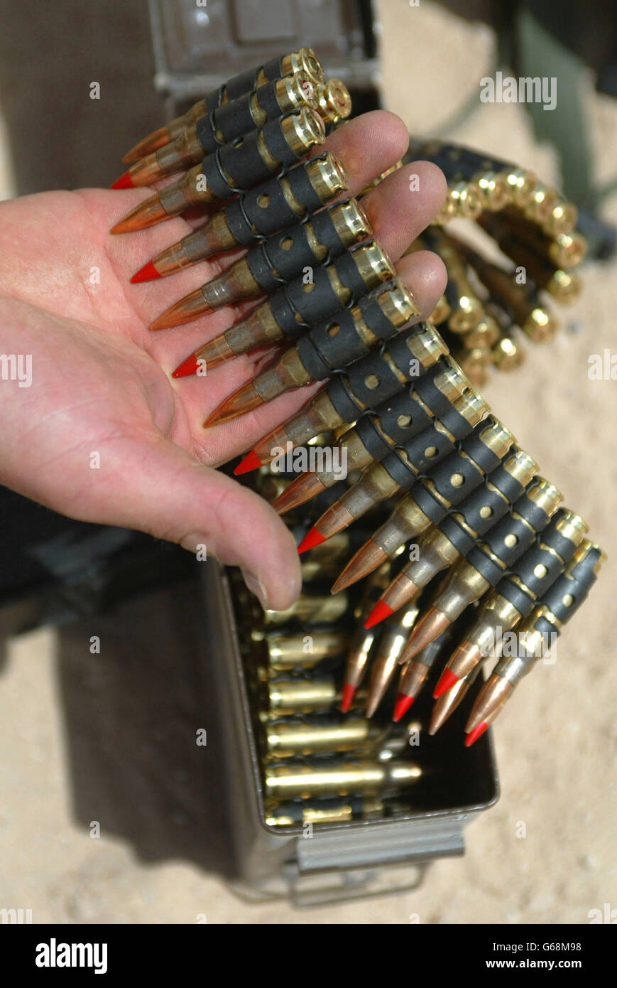 Red tipped 7.62 calibre tracer bullets for a general purpose machine gun are distributed to paratroopers of the 1st Battalion The Parachute Regiment at their camp Eagle 2 in the Kuwaiti desert. Stock Photo