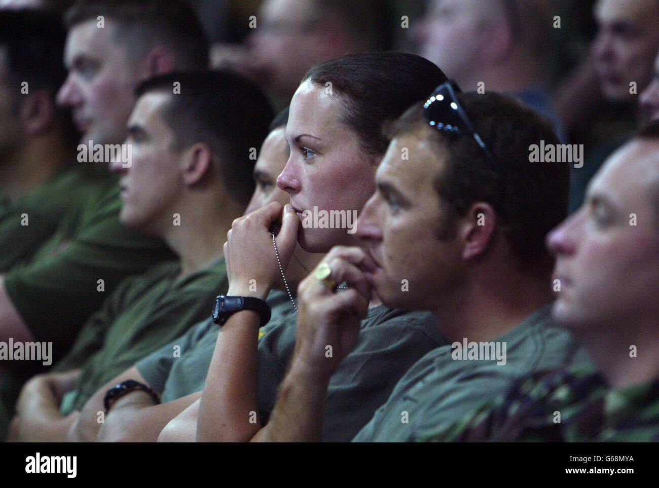 Members of the British forces listen as Group Captain Mike Harwood, who is commanding the joint British Harrier Force, updates them on the latest political developments during a briefing in their base in Kuwait. *..Aircraft from the U.S. and Britain are continuing to enforce the no fly zone over southern Iraq. US President George W. Bush started the countdown to war, in a speech giving Saddam 48 hours to quit Iraq or face invasion from 280,000 troops in the Gulf region poised for war. Saddam poured scorn on the ultimatum, his cabinet vowing to repel 'invading aggressors. Stock Photo