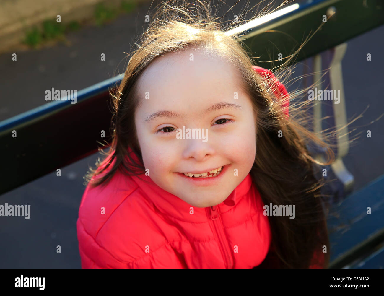 Portrait of little girl smiling outside Stock Photo - Alamy