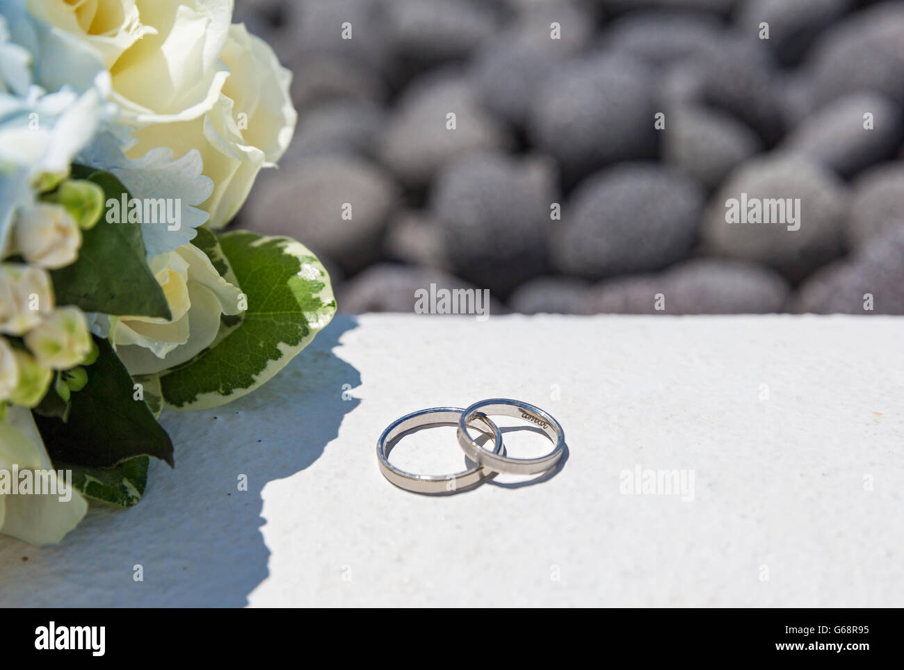 Wedding bouquet and rings on stones, on sea background Stock Photo - Alamy