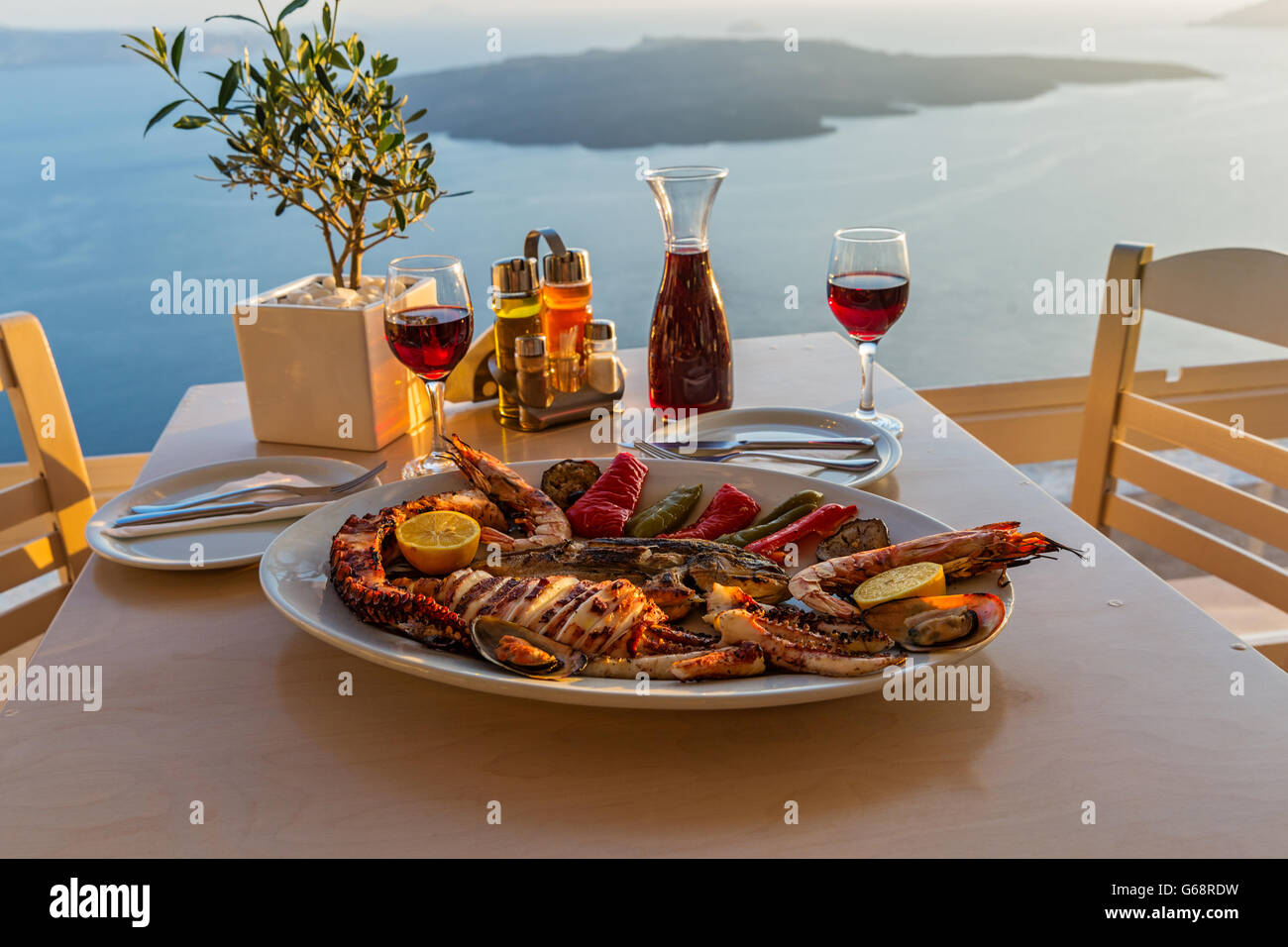 Evening dinner with seafood and red wine on the beach sea Stock Photo