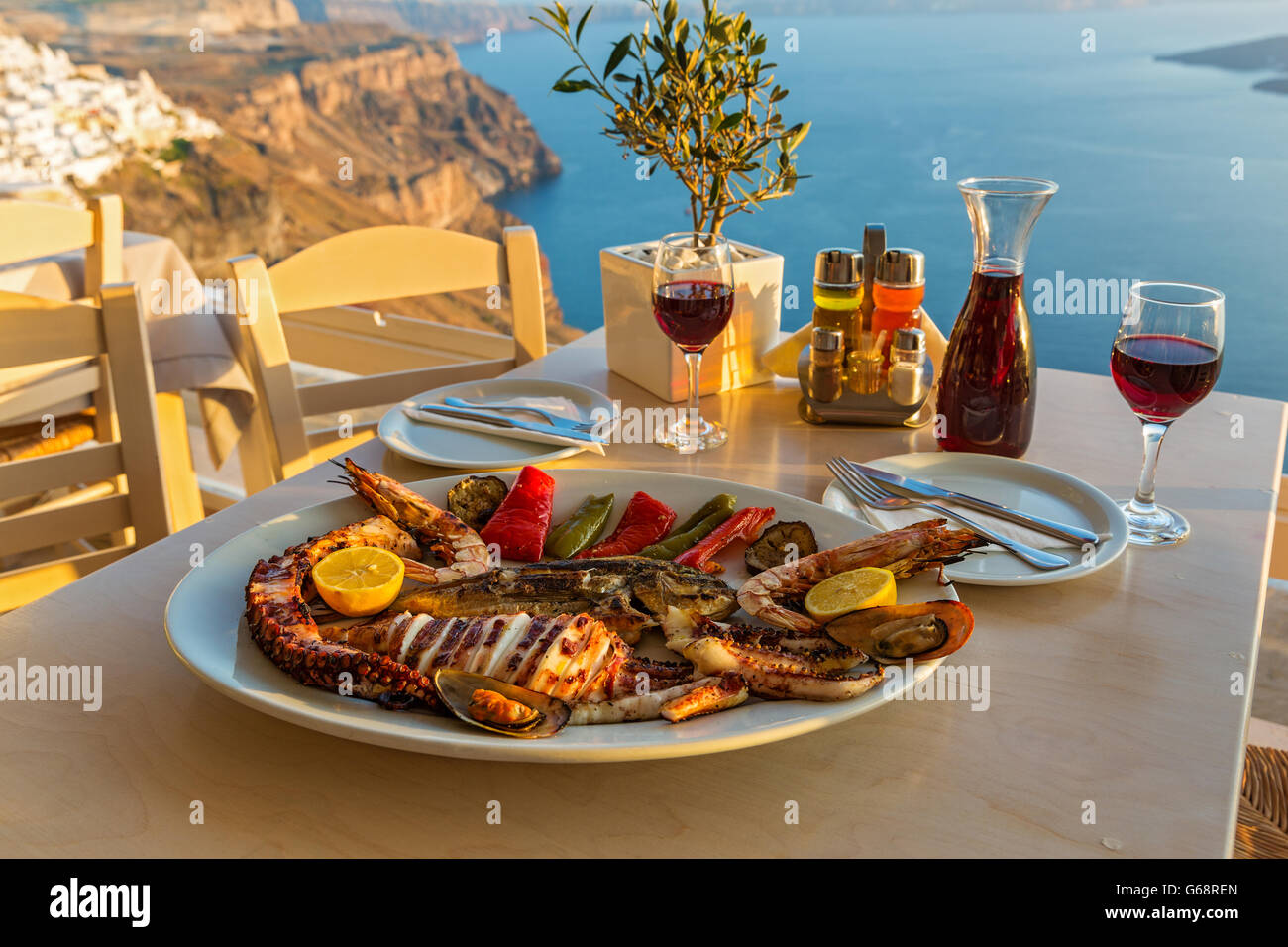 Evening dinner with seafood and red wine on the beach sea Stock Photo