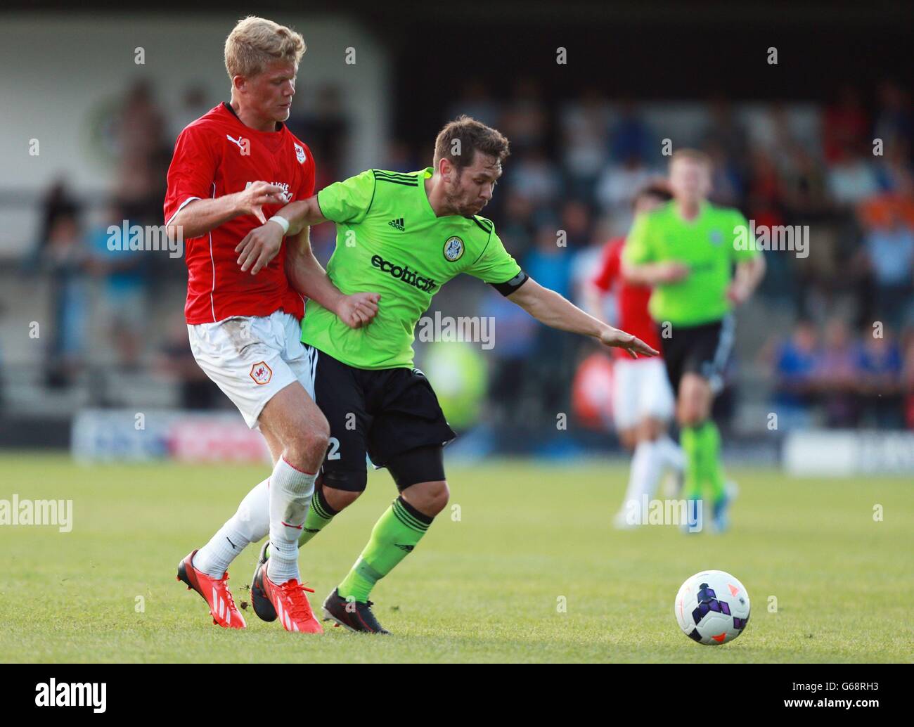 Soccer - Pre-Season Friendly - Forest Green Rovers v Cardff City - The New Lawn. Cardiff City's Alexander Cornelius challenges Forest Green Rovers Jared Hodgkiss during the pre-season friendly at The New Lawn, Nailsworth. Stock Photo