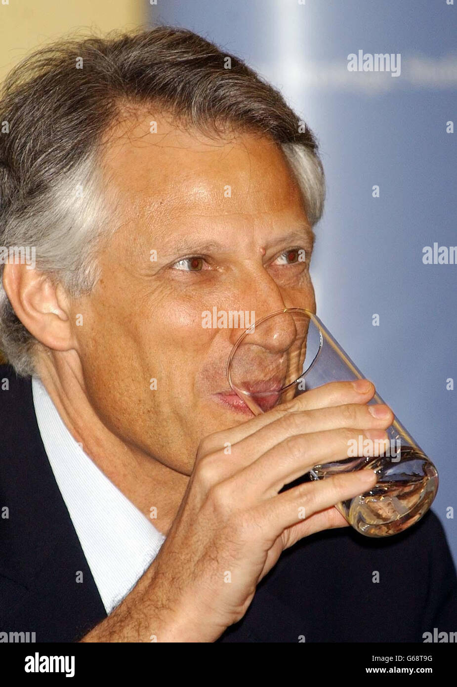 French Foreign Minister Dominique de Villepin sips a glass of water after giving the Alastair Buchan Memorial Lecture, at the International Institute for Strategic Studies in central London. He was visiting Britain for the first time since the outbreak of war in Iraq. * France has been fiercely opposed to the US and British-led military action against Saddam Hussein's regime. Stock Photo